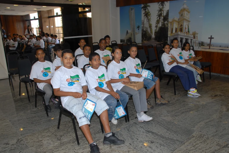 several school girls are sitting in a group with book bags