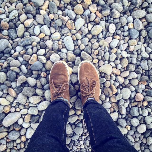 a man stands on a pebble gravel area