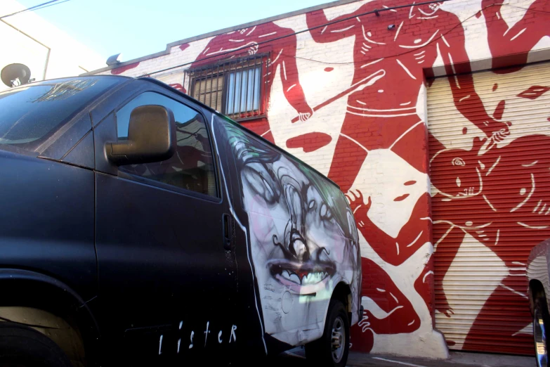 a van parked in front of a graffiti wall