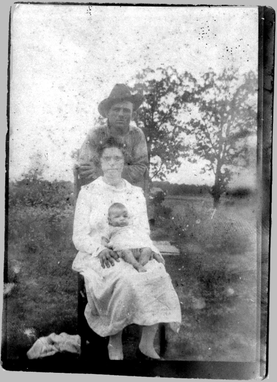 an old pograph of a family of three