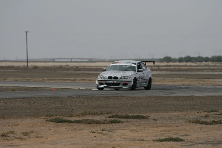 the bmw m18 race car speeds around a track