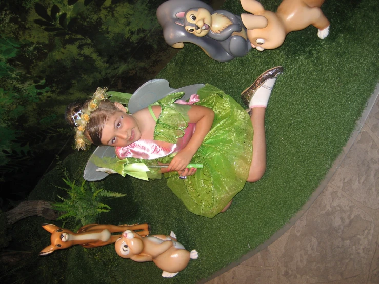 a little girl is sitting with some decorations