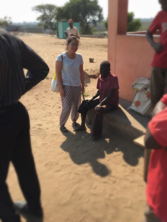 people are walking around with two women standing nearby