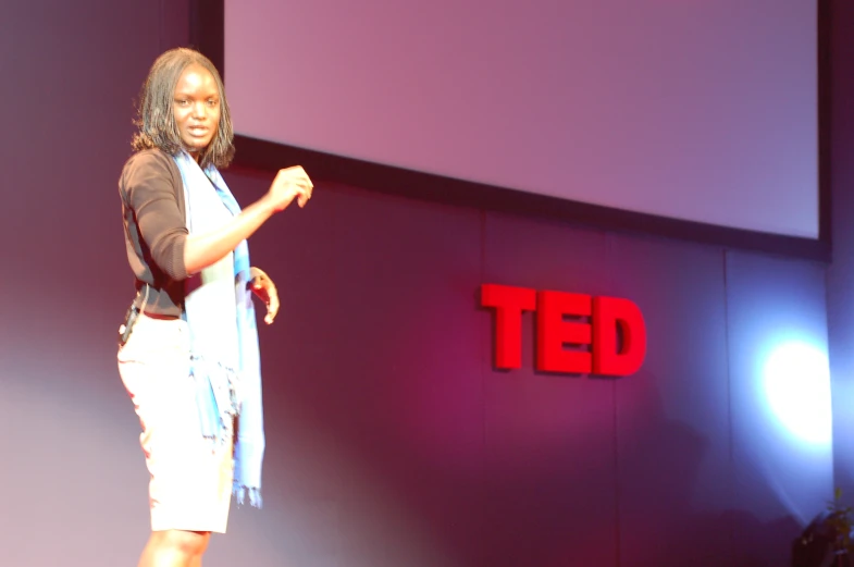 woman on stage speaking at ted ted ted