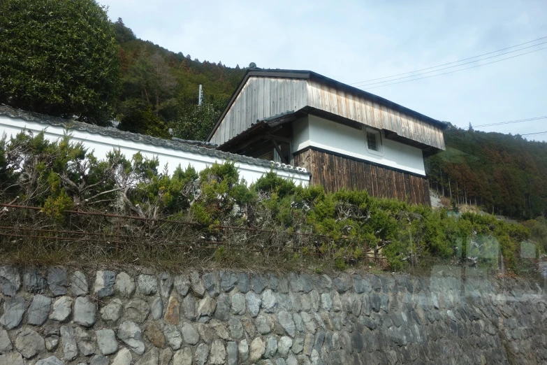 this is a house in a forest on the side of a mountain