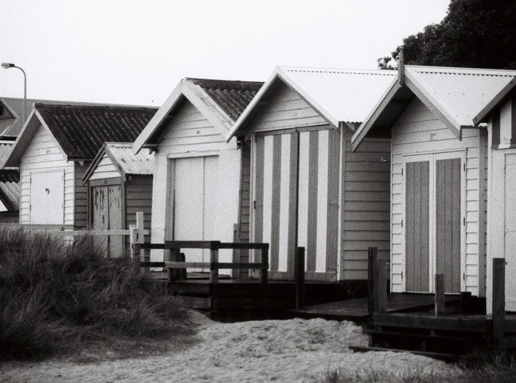 black and white po of beach huts with a water view