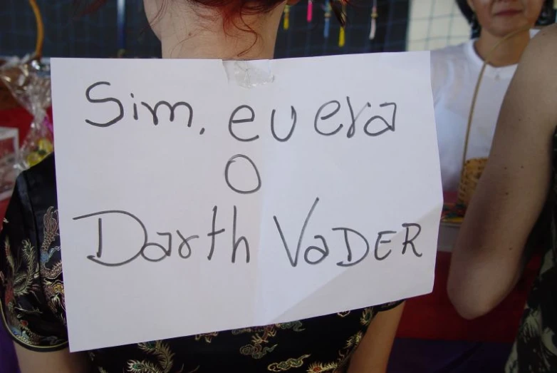 a woman holding a sign that says sin, eva 6 depath valder