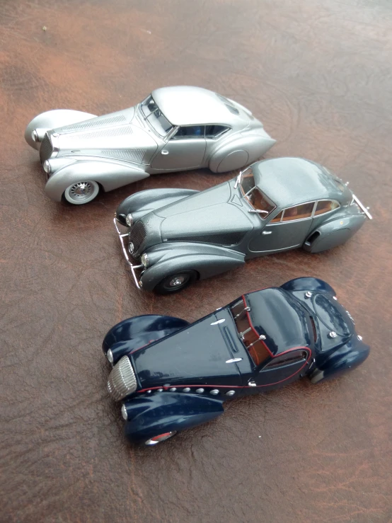 two metal model cars that look similar to some other cars