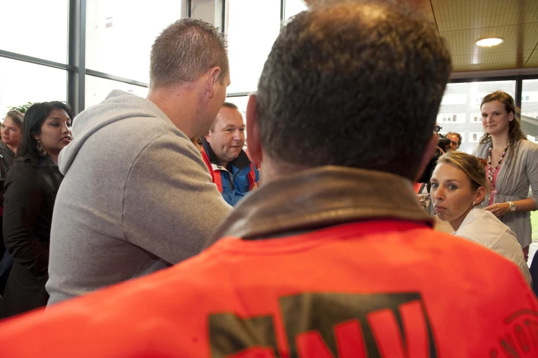 people looking at a red frisbee in the room