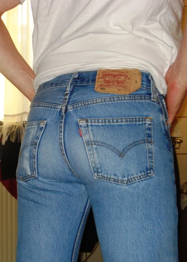 the back view of someone in jeans with a tag