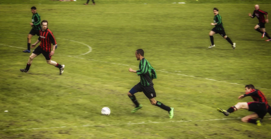 the people are playing soccer on the field