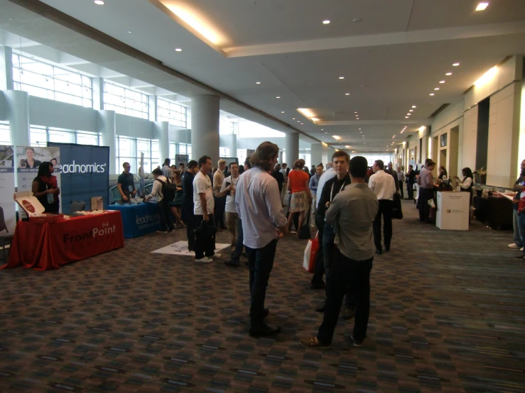 a group of people standing around a conference room