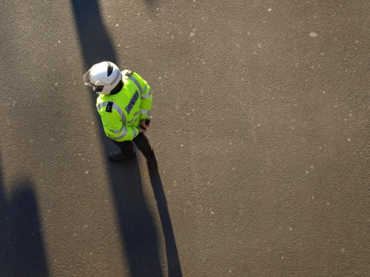 a person dressed in reflective clothing is walking