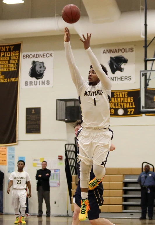 two basketball players going up to dunk the ball