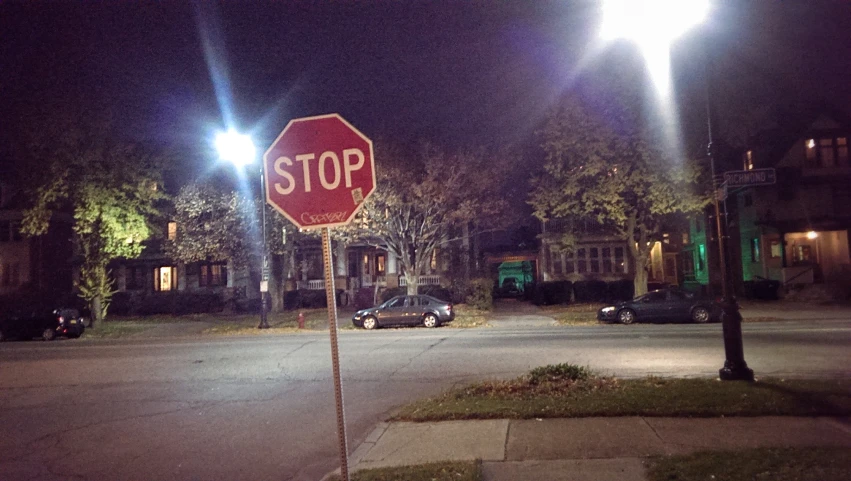 a stop sign on the sidewalk on a street