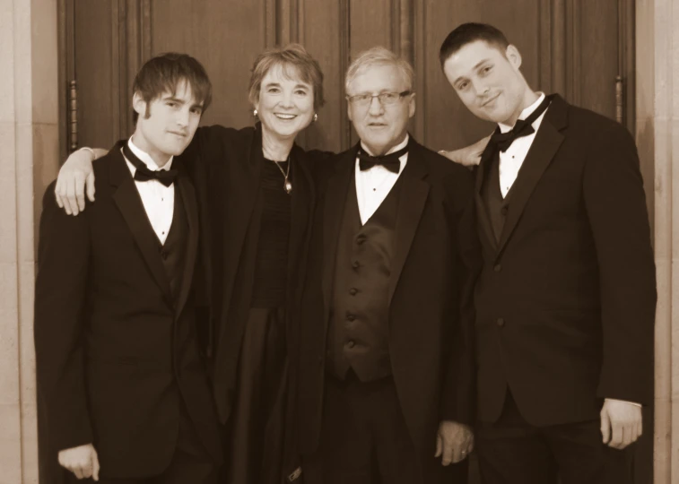 an old po of three men and a woman wearing suits