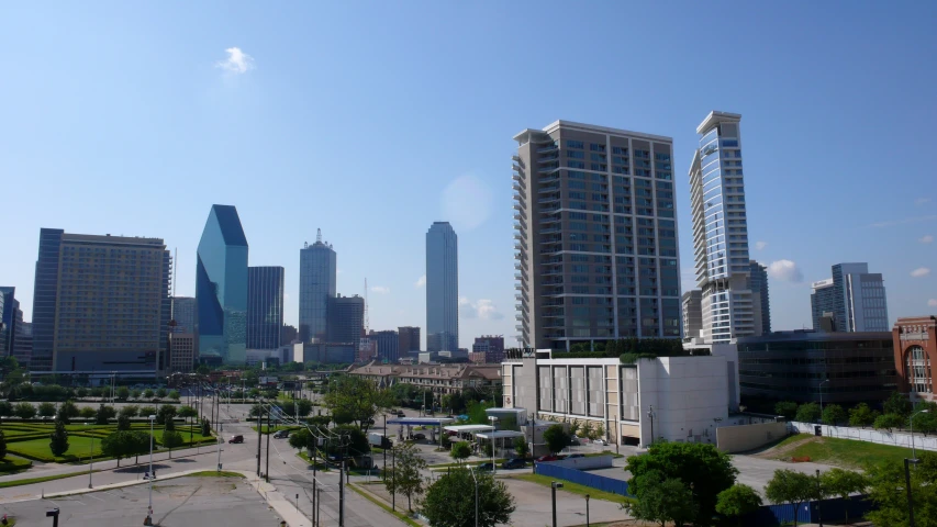 a view of a city in the background and green grass