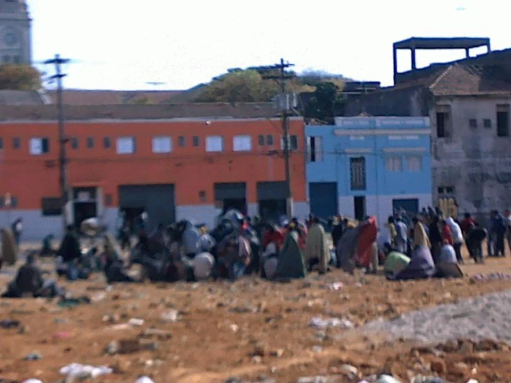 people standing outside in front of buildings that are being demolished