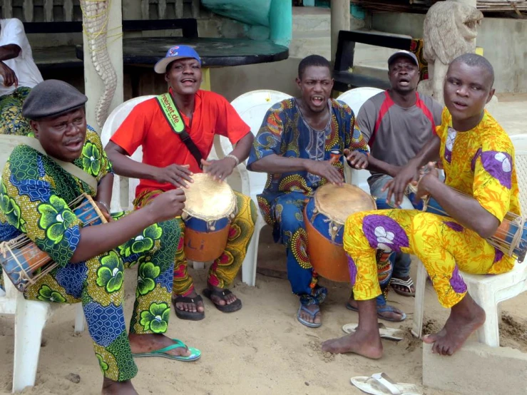 a group of men sitting around with some music