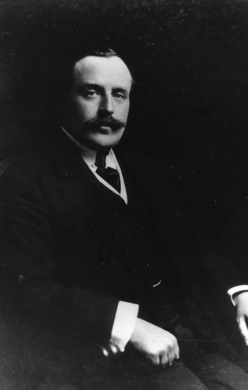 an old black and white portrait of a man in a suit