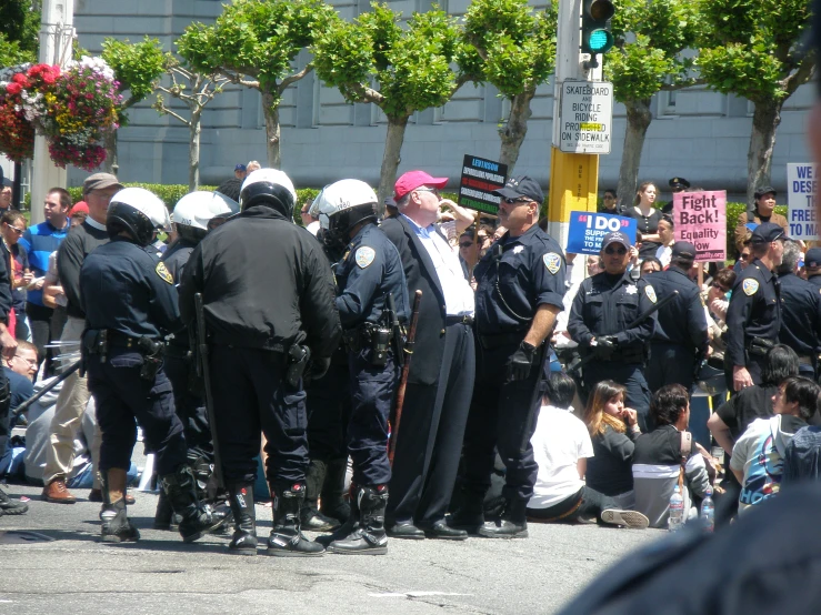 a group of men in riot gear standing on the street
