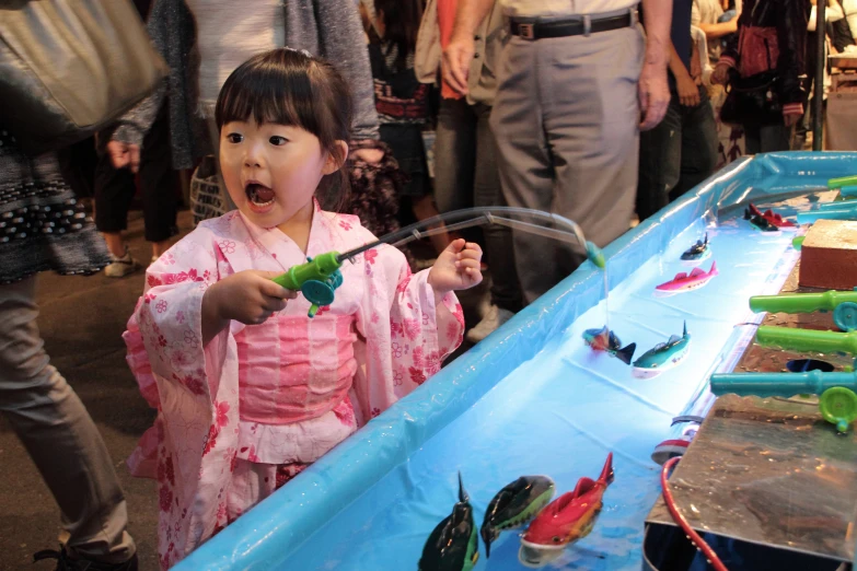 a little girl playing with toys on the pool