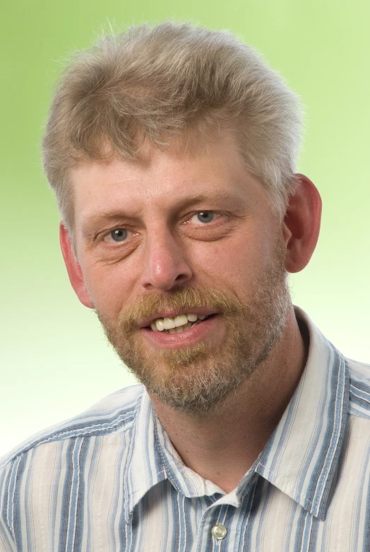 man with short hair wearing a striped shirt