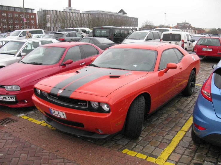 some very pretty red sports cars parked on the road