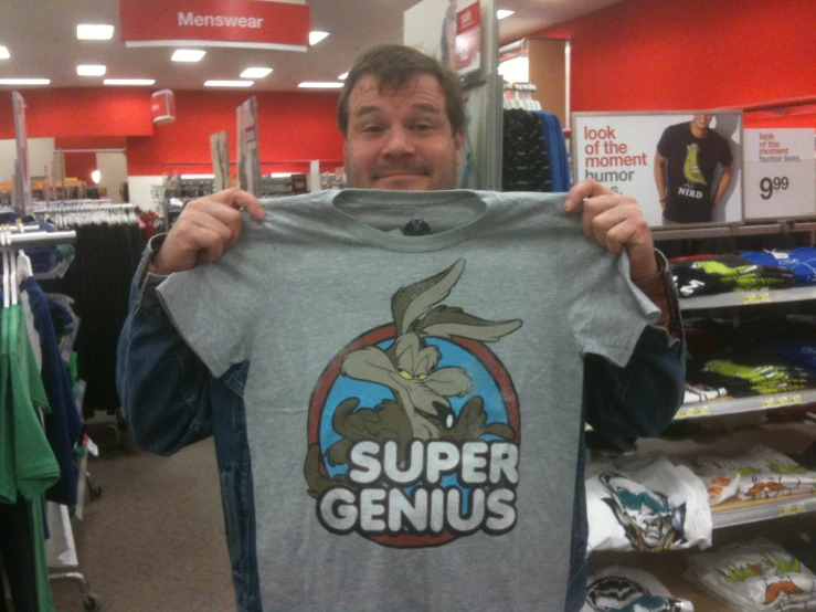 a man standing in front of a display of shirts