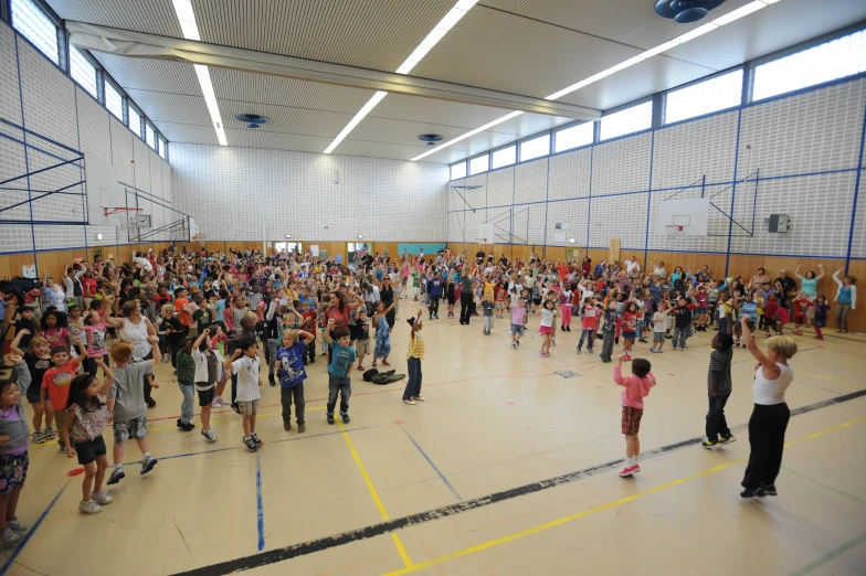 a group of children standing in an gymnasium