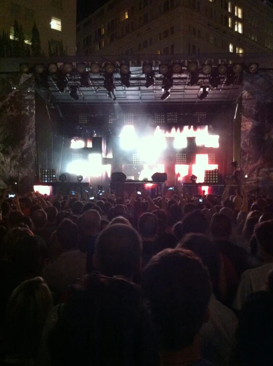 an audience at a concert standing at a podium