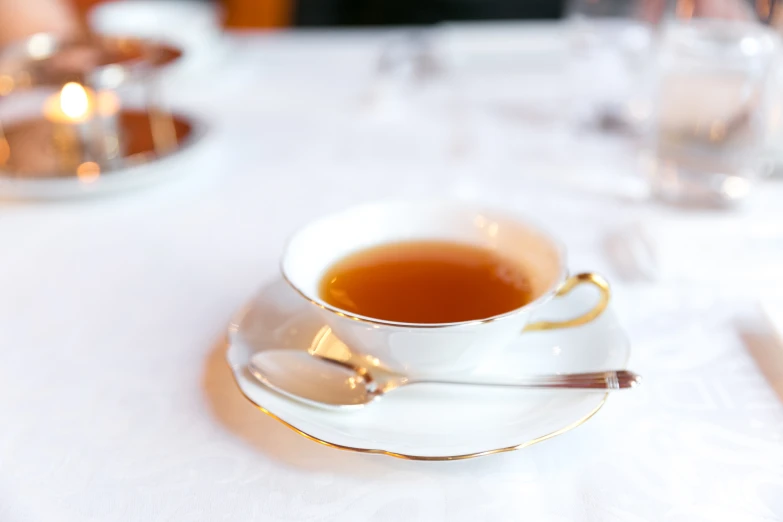 an empty tea cup sits on top of the saucer on the dining table
