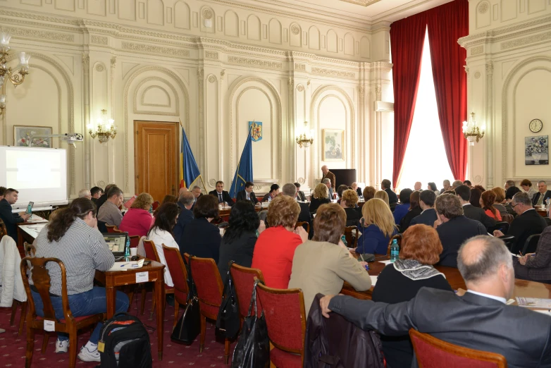 several people at a seminar in a white room