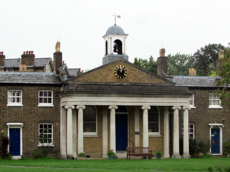 a large building with two porches and blue doors