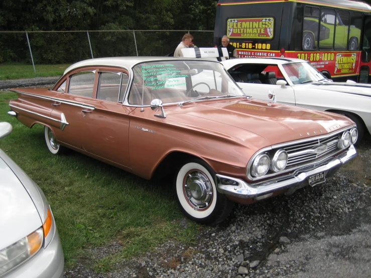 two cars parked next to each other on top of green grass