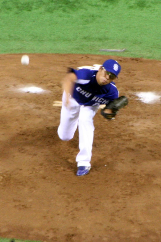 a man with a glove on standing next to home plate