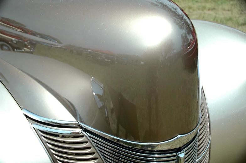 an old silver motorcycle front fender and front grille