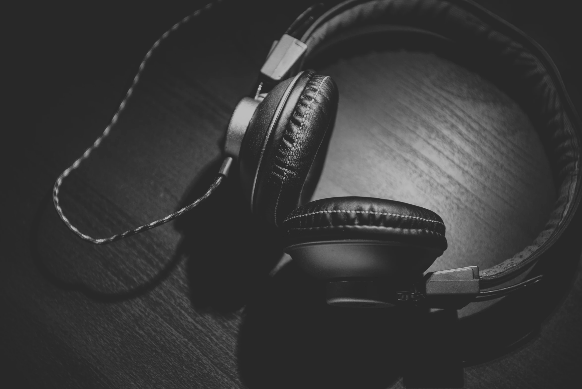 a black and white image of headphones on a table