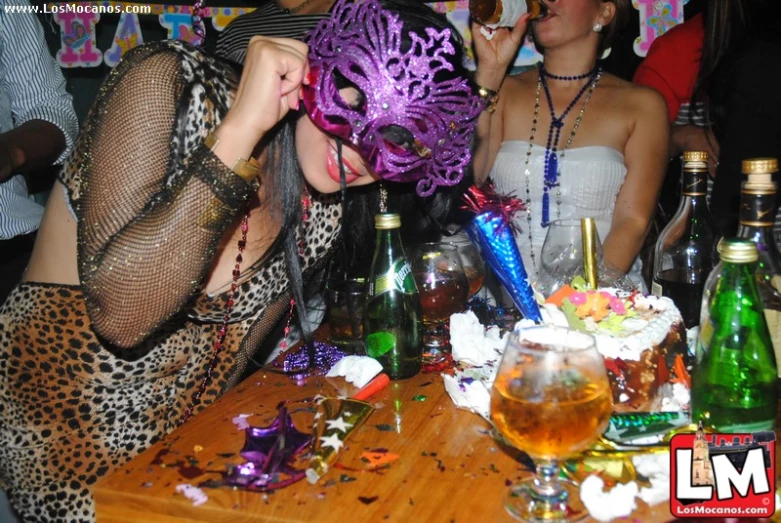 a woman that is in front of a table with some wine