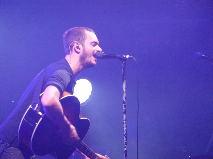 a man that is sitting down with a guitar