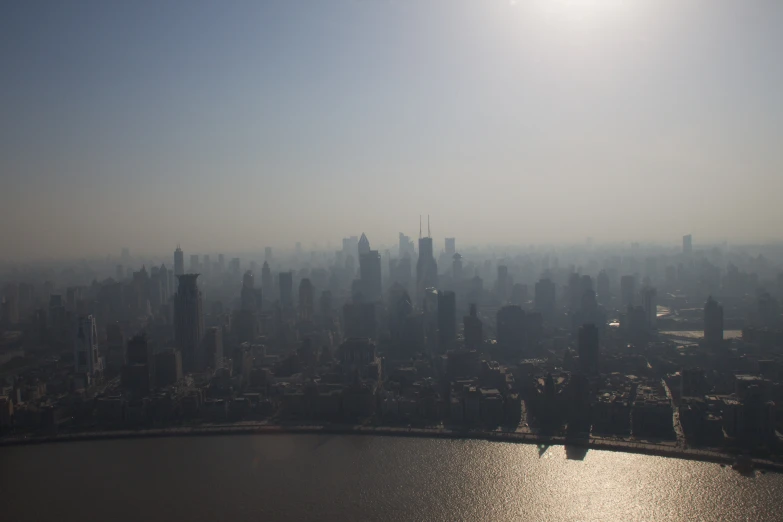 the sun shines on a city skyline as it reflects off water