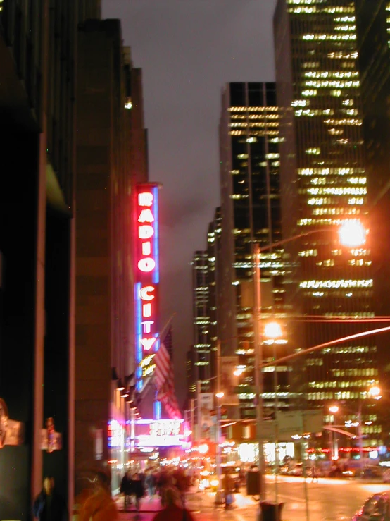 a city night scene with people in the street