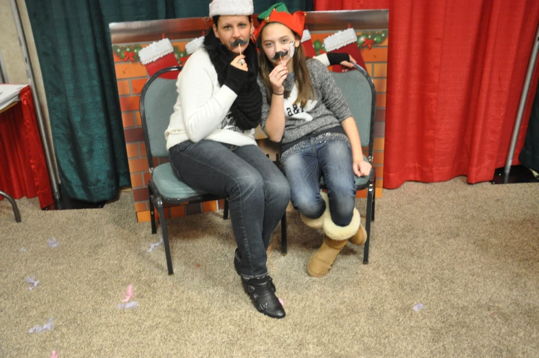 a man and woman pose on their chairs for a picture