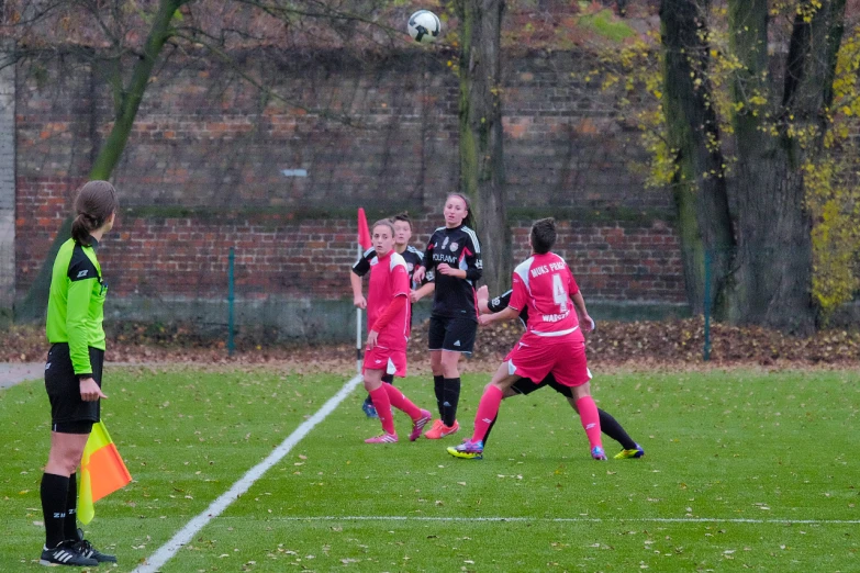 a group of women playing soccer in a field