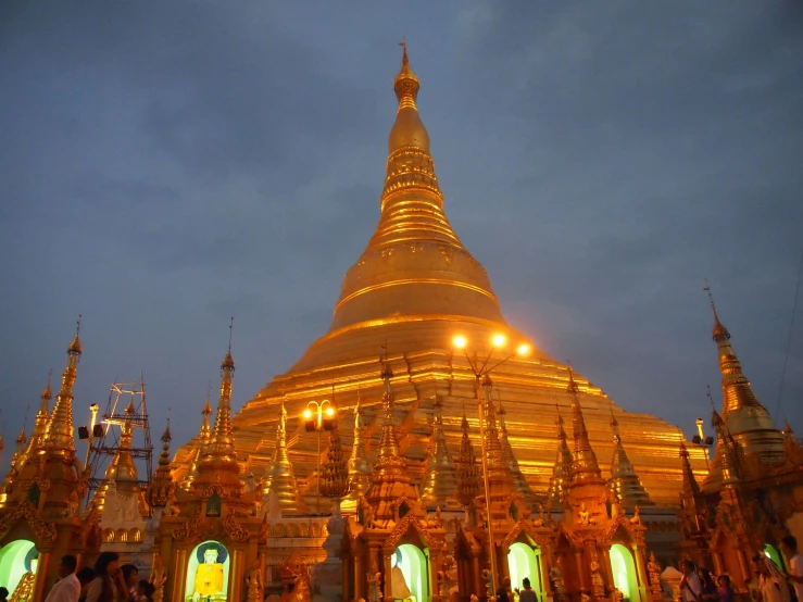 a large golden pagoda lit up at night