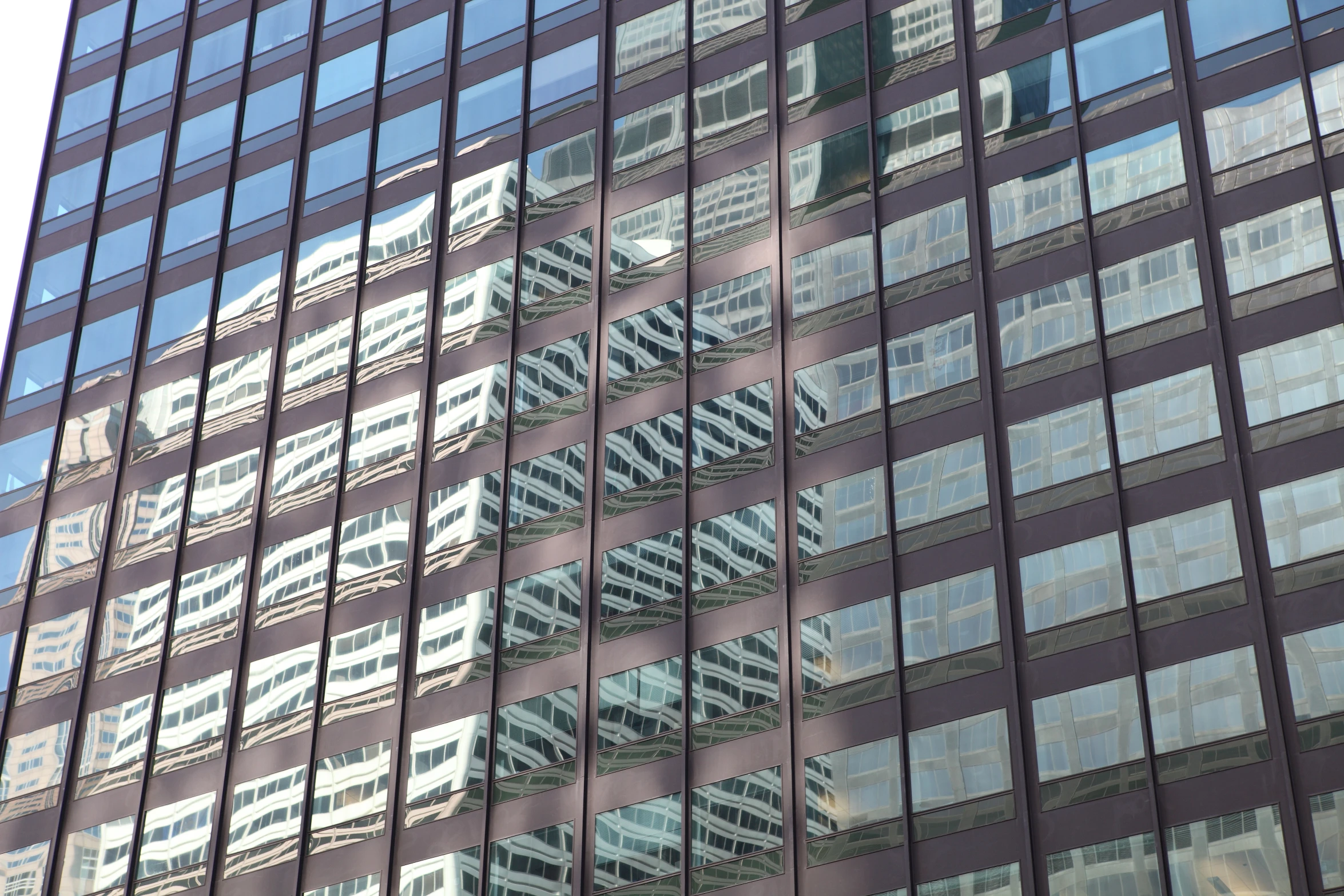 the reflection of many buildings in a large windows