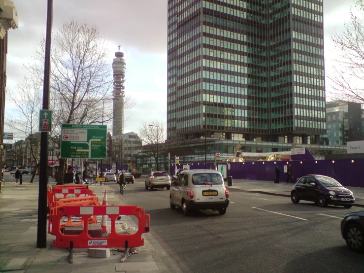 a very busy street with some cars driving on it