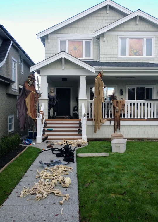 a house with large decorations and fake animals on the front yard