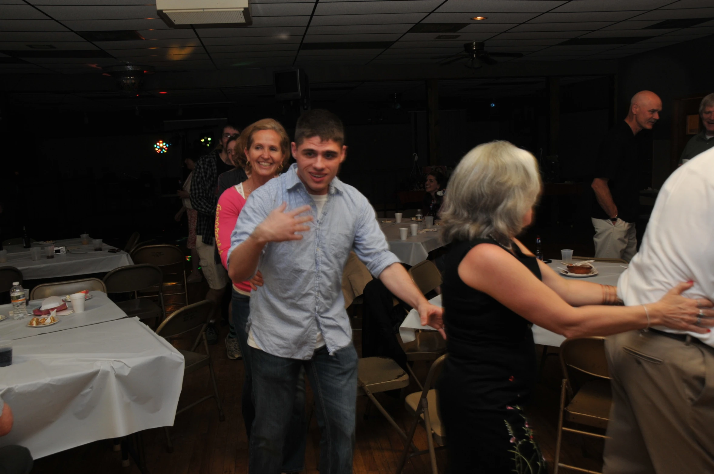 four people are standing and smiling at the camera