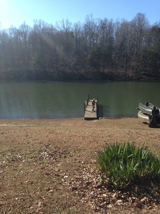 two boats are on the grass by a lake